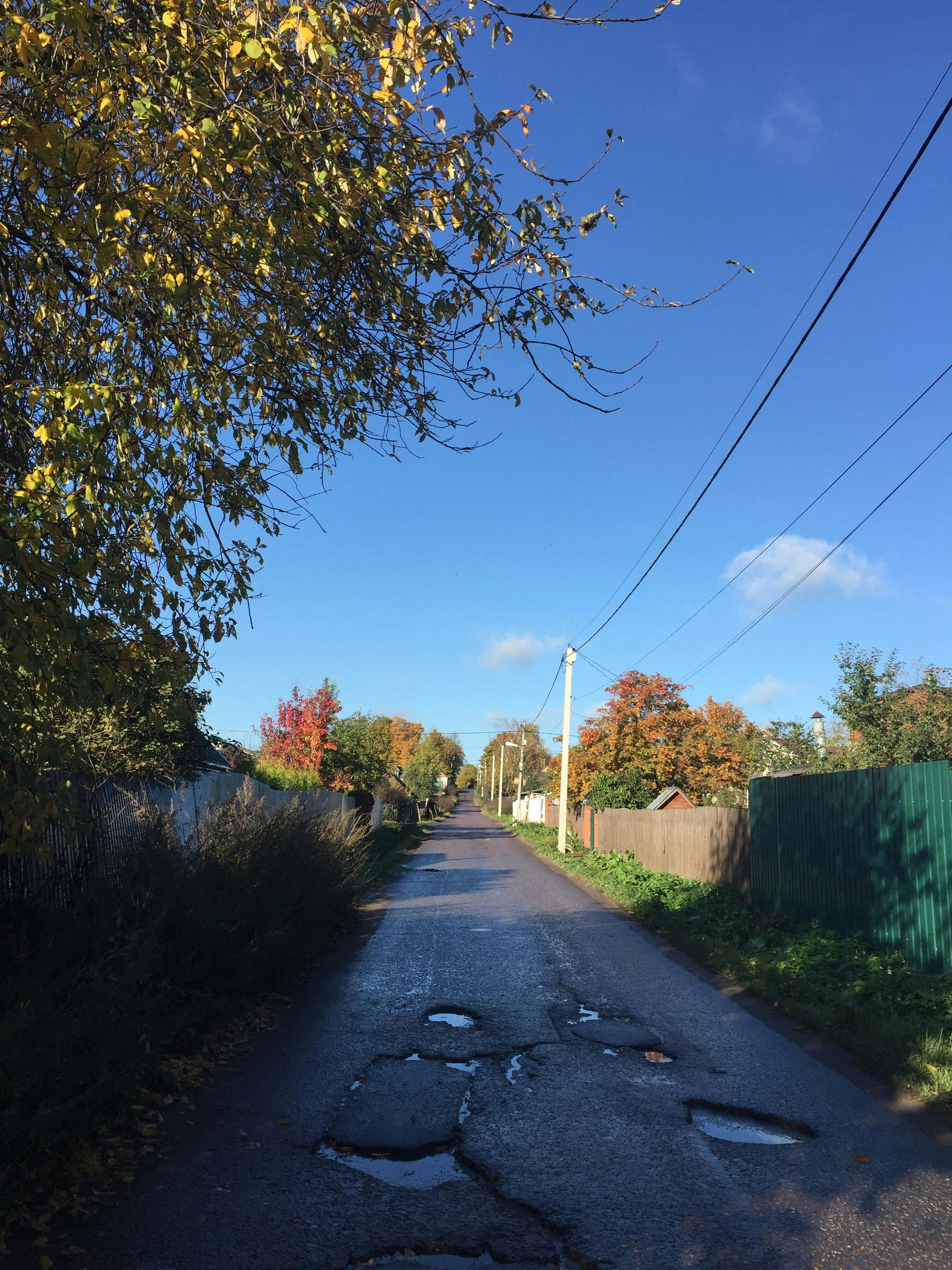 photo of a road with potholes